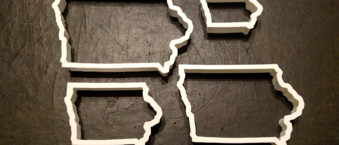 Four 3D-printed cookie cutters in the shape of Iowa