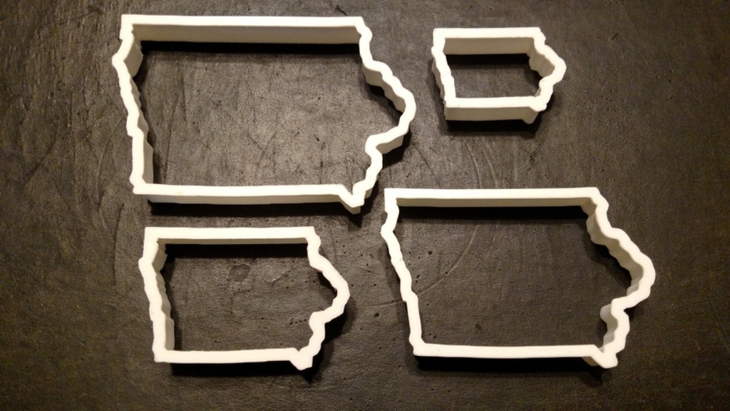 Four 3D-printed cookie cutters in the shape of Iowa